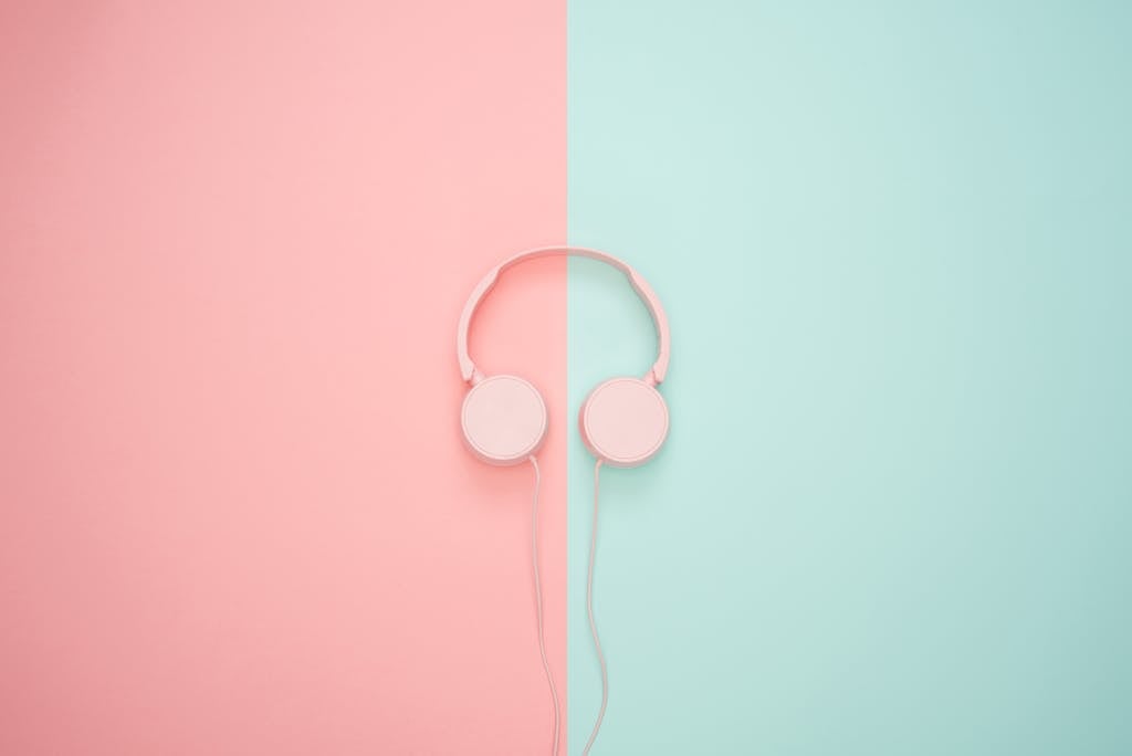 Pink Corded Headphones on pink and teal Wall